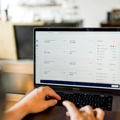 Hands typing on a laptop