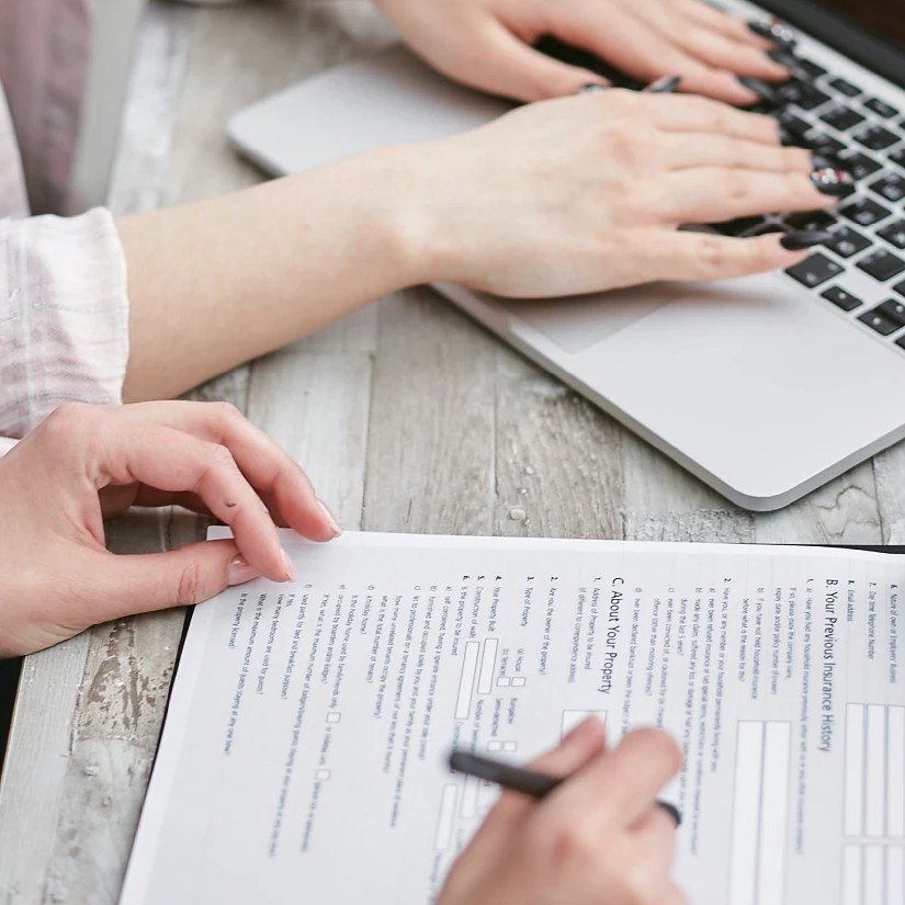 Closeup of people signing financial documents