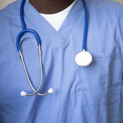 Someone in the medical field wearing a stethoscope around their neck