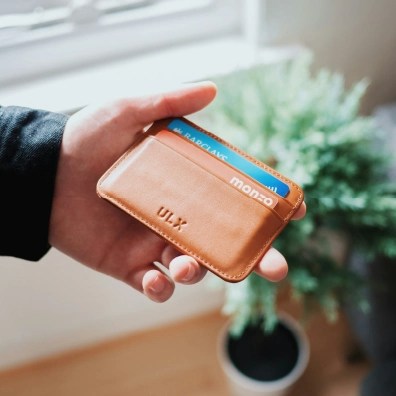 Someone holding a leather wallet in their hand
