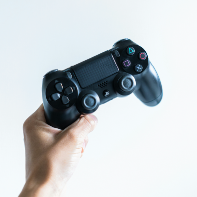 Someone holding up a gaming console.