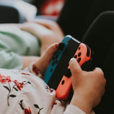 Someone holding a gaming console controller