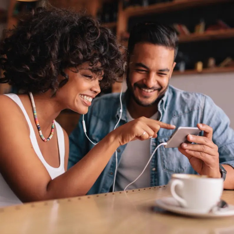 Two people watching content on a smartphone.