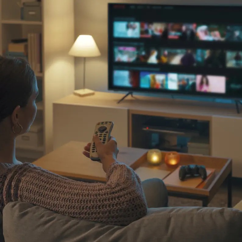 Woman watching TV at home