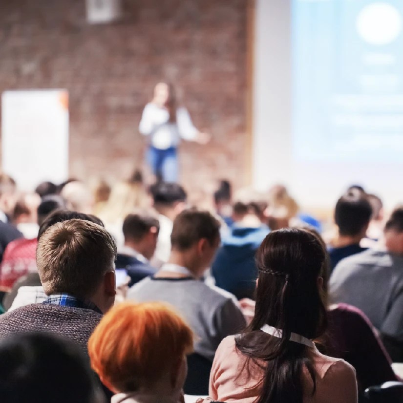 Speaker standing on stage at a conference