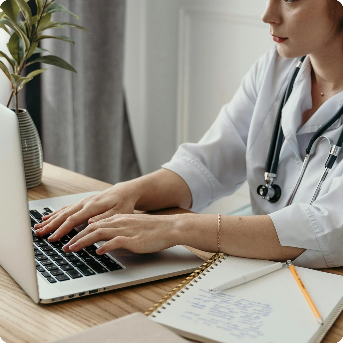 Doctor typing on laptop