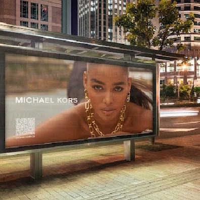 Michael Kors DOOH ad on a bus shelter