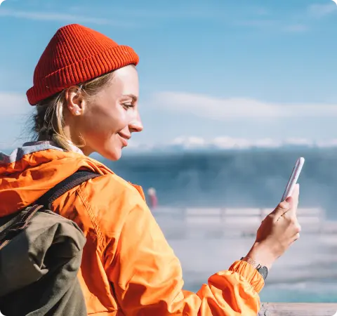 Female traveler looking at her mobile phone