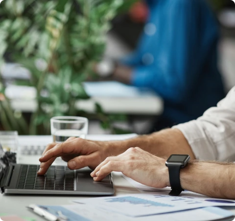 Photo of a man typing on a computer.